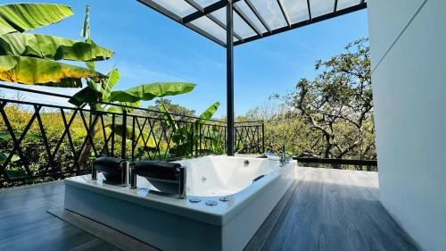 a bathroom with a tub on a balcony with a view at Luxe Glamping in Moniquirá