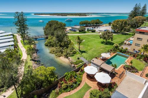 an aerial view of a resort with a pool and the ocean at Sails Resort Caloundra in Golden Beach