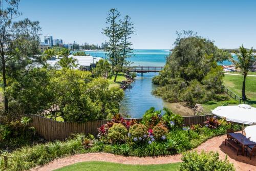 a view of a river from a garden at Sails Resort Caloundra in Golden Beach