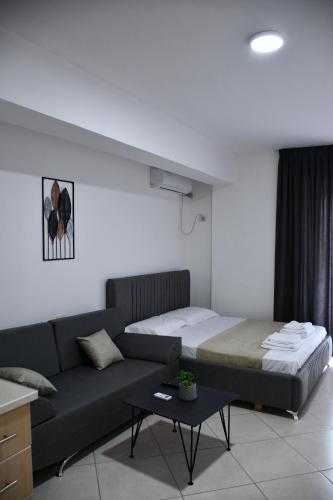 a living room with a bed and a couch at Apartament Niko Shengjin 1 in Shëngjin