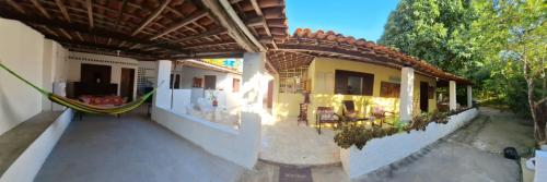 an outside view of a house with a hammock at Maceió casa na praia de Ipioca- Paraíso das águas in Maceió
