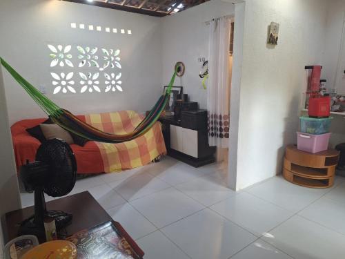 a living room with a hammock in a room at Maceió casa na praia de Ipioca- Paraíso das águas in Maceió
