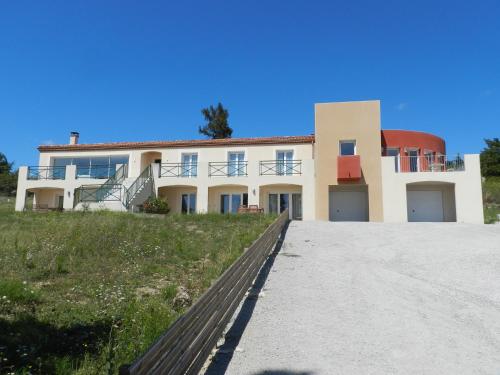 a house on top of a hill with a driveway at Domaine de Campras B&B in Saissac