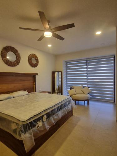 a bedroom with a bed and a ceiling fan at Luxury Condo Riviera Nayarit in Cedro