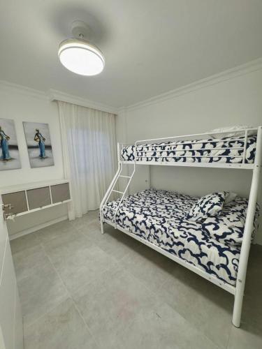 a bedroom with a bunk bed in a room at CASA TINA piscina privada in Candelaria