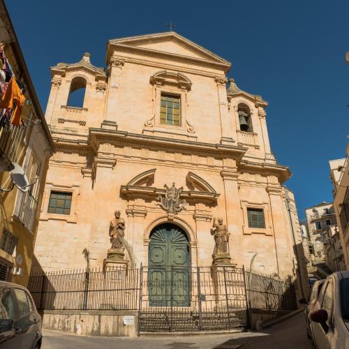 a building with a green door on a street at Casa Dava in Modica