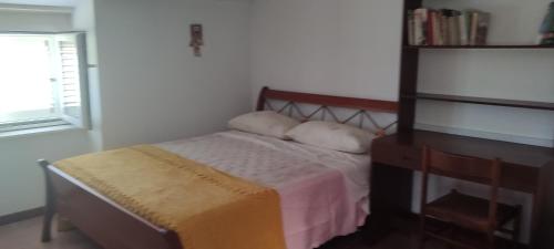 a small bedroom with a bed and a dresser at Casa vacanze Nonno Baffo 2 in Canosa Sannita