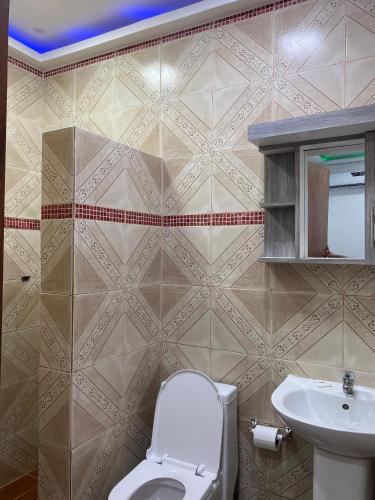 a bathroom with a toilet and a sink at Posada Restaurant La Guaricha in Catia La Mar