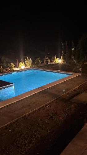 a large swimming pool at night at The Stonehouse in Ulcinj