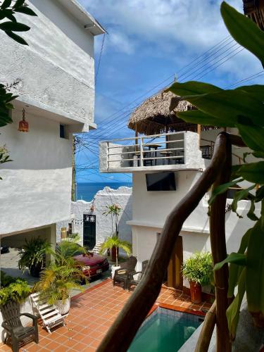 a balcony of a house with a swimming pool at Posada Restaurant La Guaricha in Catia La Mar