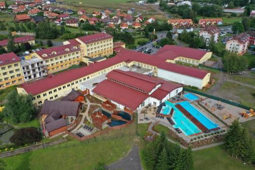 an overhead view of a large building with a swimming pool at Exclusive HOTEL Lipno Wellness & SPA in Frymburk
