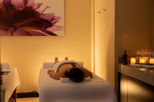 a child laying on a bed in a hotel room at Casa Andina Select Tacna in Tacna