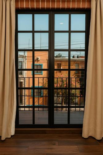 a window with a view of a building at Hotel Casa Acueducto - Lujo Cultural in Oaxaca City