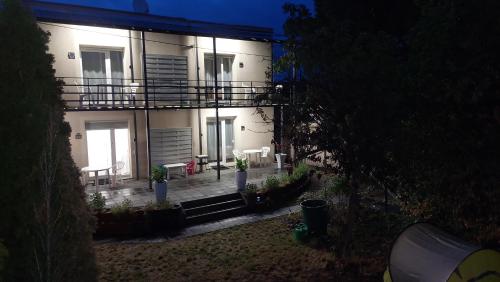 a large white building with a patio at night at Hotel Konty in Kąty Opolskie