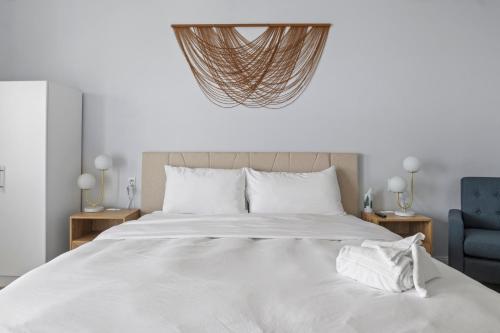 a bedroom with a large white bed and a blue chair at Showboat Hotel in Himrod
