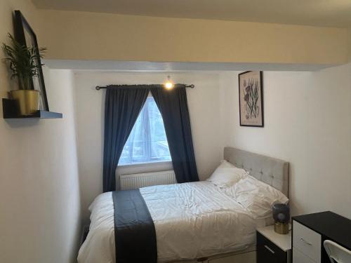 a bedroom with a bed and a window at Snug room II in Wellingborough in Wellingborough