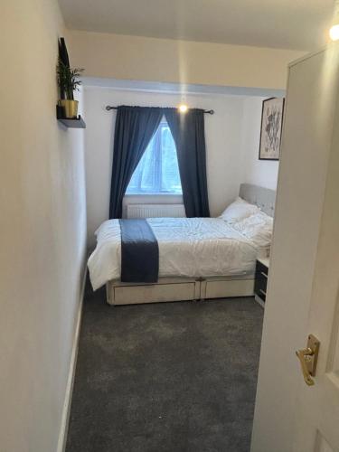 a bedroom with a bed and a window at Snug room II in Wellingborough in Wellingborough