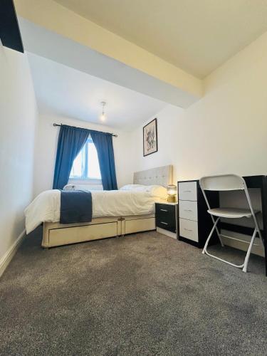 a bedroom with a bed and a desk and a chair at Snug room II in Wellingborough in Wellingborough