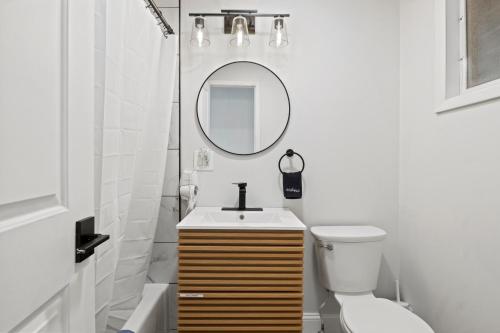 a bathroom with a sink and a mirror and a toilet at Showboat Hotel in Himrod