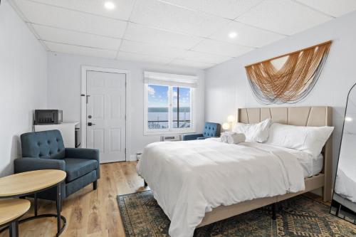 a bedroom with a bed and a table and a chair at Showboat Hotel in Himrod