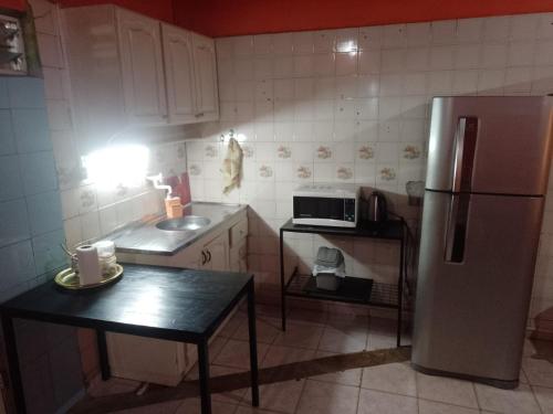 a kitchen with a refrigerator and a table in it at Casa de huéspedes en Posadas in Posadas