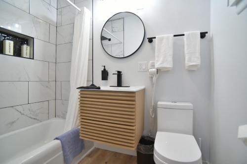 a bathroom with a sink and a toilet and a mirror at Showboat Hotel in Himrod