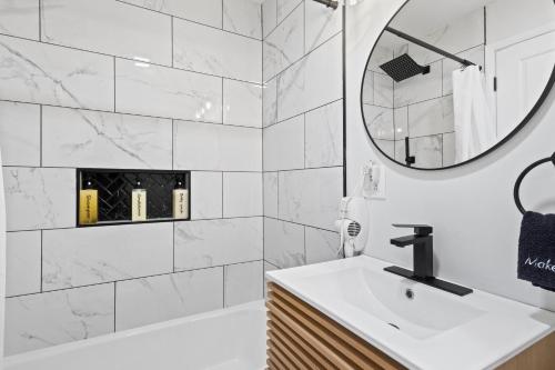 a white bathroom with a sink and a mirror at Showboat Hotel in Himrod