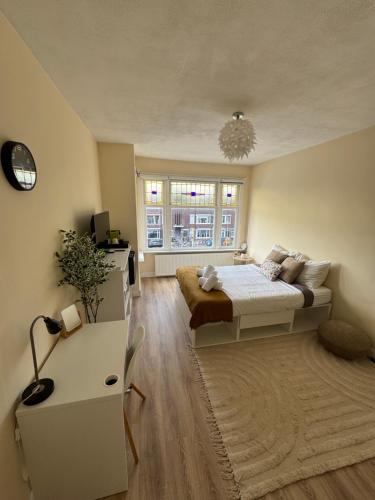 a bedroom with a bed and a window at Spacious Cosy Room With Private Bathroom in The Hague