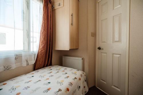 a small bedroom with a bed and a window at Decker’s in Leven-Fife