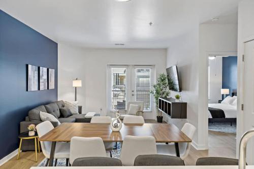 a living room with a couch and a table and chairs at Modern 2BD - 5 Min DT, Gym, Parking, W-D - Sleeps 12 in Charlotte