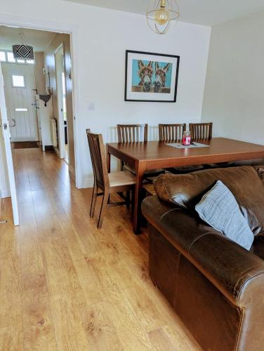 a living room with a couch and a wooden table at Sleeps up to 8 guests - Modern townhouse near Newcastle in Willington Quay