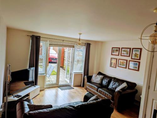 a living room with two couches and a television at Sleeps up to 8 guests - Modern townhouse near Newcastle in Willington Quay