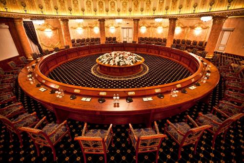 a large stage in a large auditorium with chairs at Multi Grand Pharaon Hotel in Yerevan