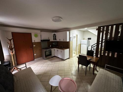 a kitchen with white cabinets and a table and chairs at Cozy & Accessible Home, Just Like Yours! in Golem