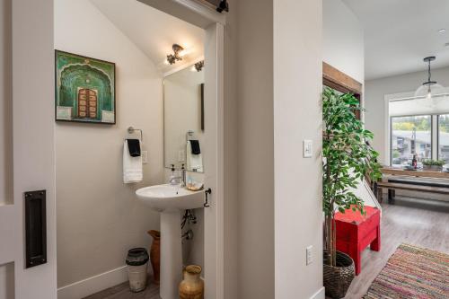 a bathroom with a sink and a mirror at Hideaway Station TS 23 - New in Downtown Winterpark in Winter Park