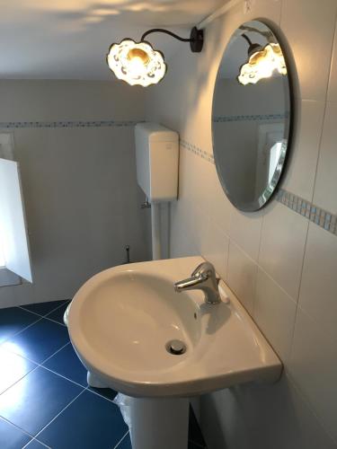 a bathroom with a sink and a mirror at B&B Villa sul Mare in Melito di Porto Salvo