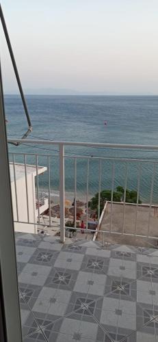 a balcony with a view of the beach and the ocean at Sunset Boulevard Rooms in Qeparo