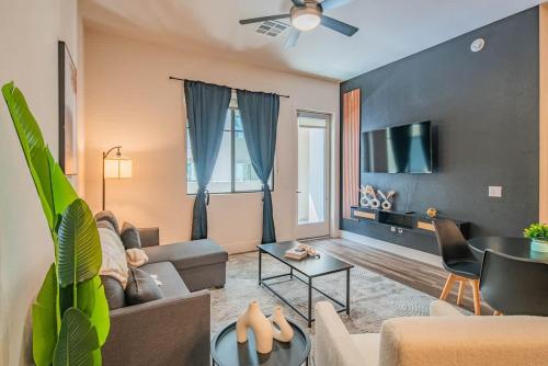 a living room with a couch and a tv at Luxe 1BR Kierland Commons, TPC Golf, Pool, Gym, W-D in Scottsdale