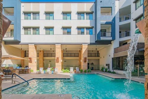 a swimming pool in front of a building at Luxe 1BR Kierland Commons, TPC Golf, Pool, Gym, W-D in Scottsdale
