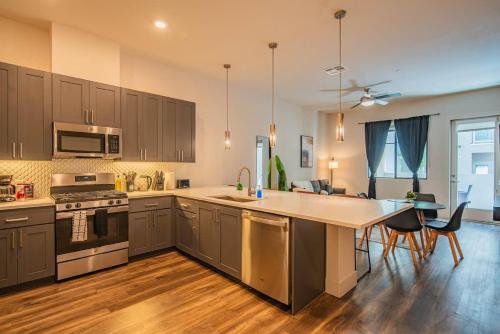 a kitchen with a large island in the middle at Luxe 1BR Kierland Commons, TPC Golf, Pool, Gym, W-D in Scottsdale