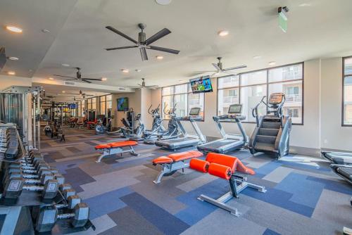 a gym with several treadmills and machines in a room at Modern 1BR Kierland Commons, TPC Golf, Pool, Gym, W-D in Scottsdale
