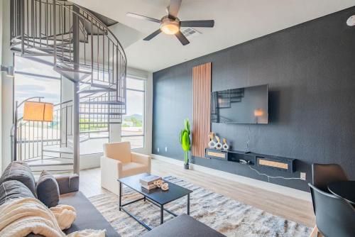 a living room with a couch and a tv at Kierland Commons, Private Rooftop, TPC Golf, Pool, Gym in Scottsdale