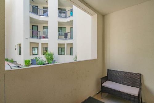 a bench in a room with a large window at Modern 1BR Kierland Commons, TPC Golf, Pool, Gym, W-D in Scottsdale