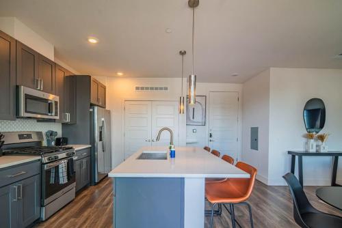 a kitchen with a sink and a counter top at Peaceful 1BR Kierland Common, TPC Golf, Pool, Gym, W-D in Scottsdale
