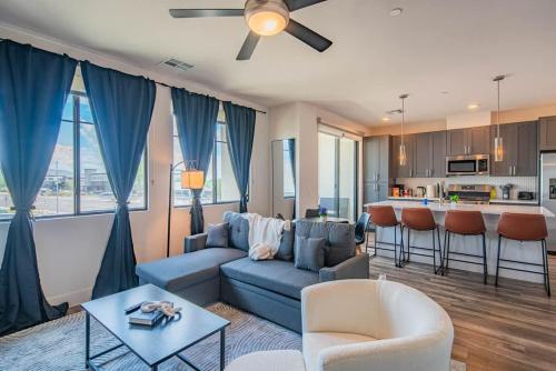 a living room with a blue couch and a kitchen at Peaceful 1BR Kierland Common, TPC Golf, Pool, Gym, W-D in Scottsdale