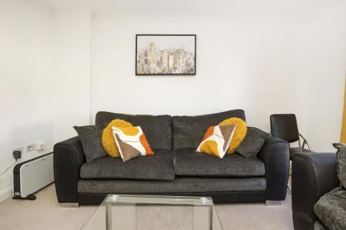 a living room with a couch and a table at Stunning 2-BR Home Gravesend Town Centre, Kent in Gravesend