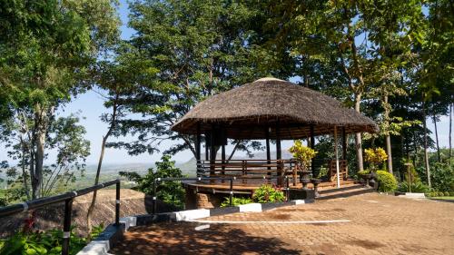 a wooden gazebo with a straw roof at Villa Kupa in Zomba