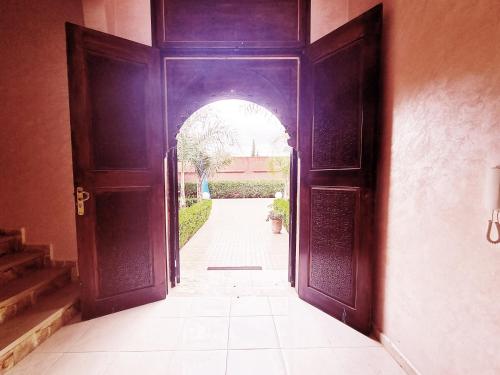 an open door to a hallway with a tile floor at Hotel&Restaurant Atlas Symphony in Ourika