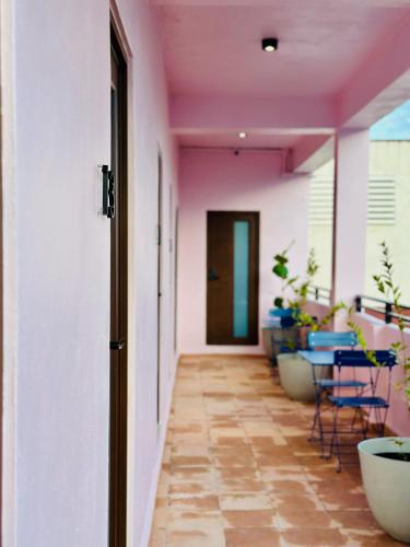 a hallway with chairs and tables and a pink ceiling at Room 8 Colorful Crash Pad Near Cerra Art in San Juan