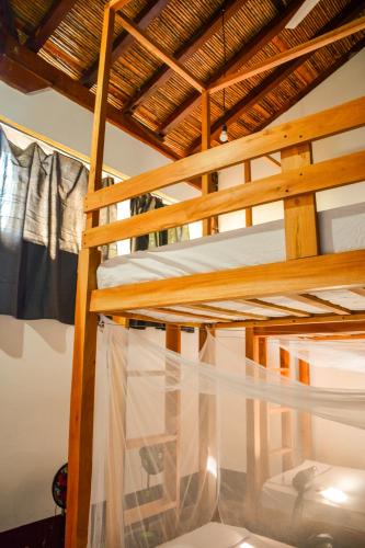 a bunk bed in a room with clothes hanging at Casa Gallo Pinto in Granada